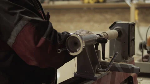 The carpenter with the help of a tool gives shape to wooden blanks on a machine. Stock Footage 218595481