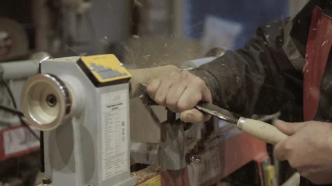The carpenter with the help of a tool gives shape to wooden blanks on a machine. Stock Footage 218595526