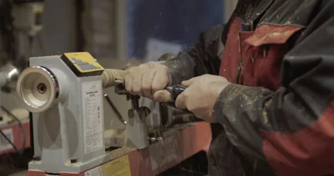 The carpenter with the help of a tool gives shape to wooden blanks on a machine. Stock Footage 218598826
