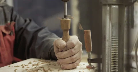 The carpenter with the help of a tool gives shape to wooden blanks on a machine. Stock Footage 218601062