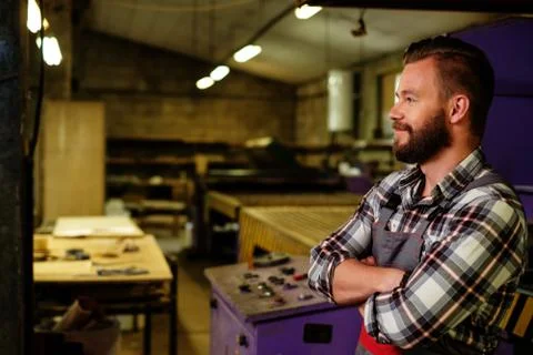 Carpenter on his workplace in carpentry workshop Stock Photos