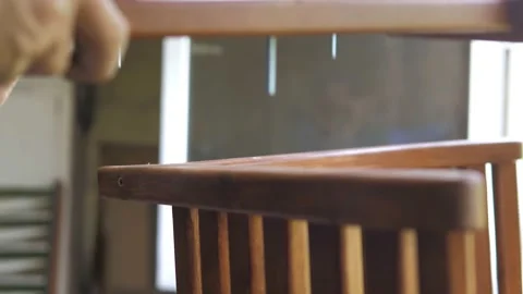 A carpenter in his workshop assembles a handmade chair, screws a bolt, secures Stock Footage 202130114