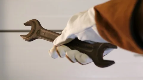 Carpenter holding Spanner tool size 32 30. Worker hand wearing white gloves POV. Stock Footage 126339318