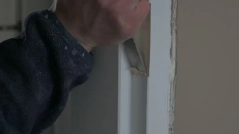 The carpenter installation the lock into the door with a chisel and a hammer Video stock 178459142