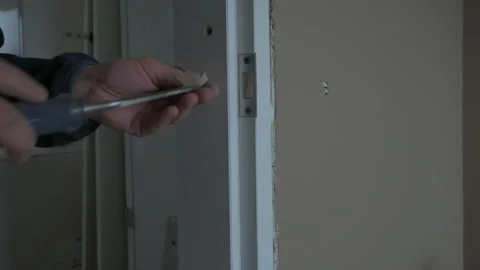 The carpenter installation the lock into the door with a chisel and a hammer Stock-Footage 178465966