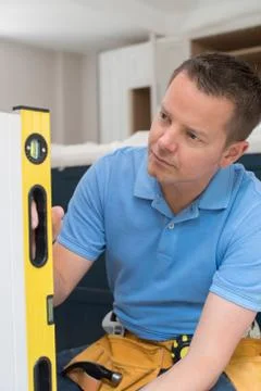 Carpenter Installing Luxury Fitted Kitchen Stock Photos
