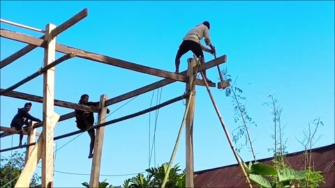 Carpenter installing wooden house frame in South Sulawesi, East Indonesia Stock Footage 285542237