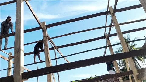 Carpenter installing wooden house frames in South Sulawesi, Indonesia Stock Footage 285542225