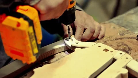 Carpenter joiner assembling furniture in which the parts Stock Footage 285542297
