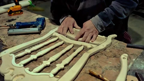 Carpenter joiner assembling furniture in which the parts Stock Footage 285542319