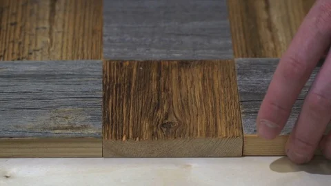 Carpenter labor master work with wood. Master puts and sticks squares from old Stock Footage 80095422