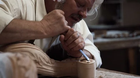 Carpenter leads hands and looking carving wooden detail Furniture. Stock Footage 112627724