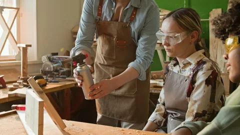 Carpenter Lighting Gas Torch and Directing Flame at Wooden Detail during Lesson Stock Footage 334432100