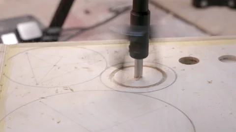 Carpenter makes hole in wood with adjustable circle cutter Stock Footage 194228692