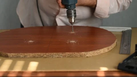 The carpenter makes holes in the slab with a drill. Stock Footage 222055681