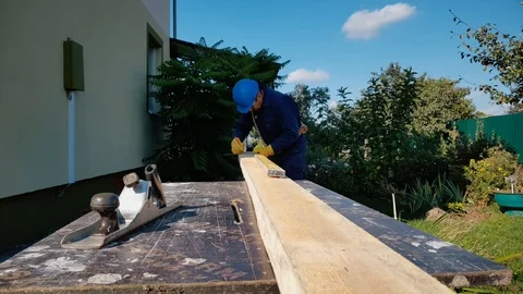 Carpenter makes marks on board Stock Footage 99019629