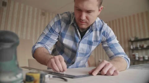 Carpenter makes pencil markings on the blank with the help of a ruler Stock Footage 153495324