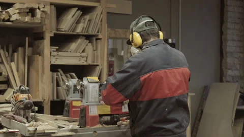 The carpenter makes the processing of wood blanks in the workshop. Stock Footage 218595416
