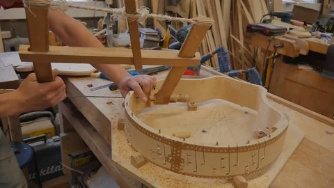 Carpenter making base of harp Stock-Footage 79835484