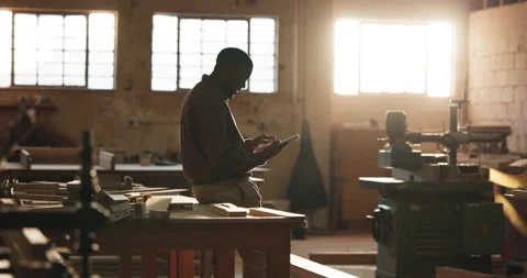 Carpenter, man and scroll in factory with tablet, research and check quote for Video stock 341377903