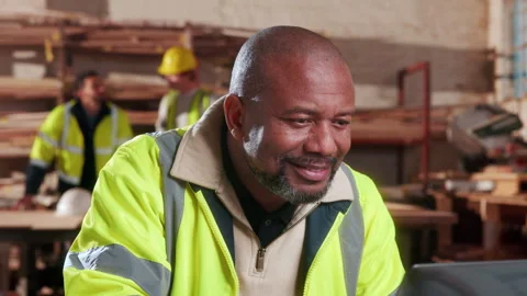 Carpenter, man and smile in workshop with laptop, good news and email for Stock Footage 338049385