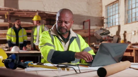 Carpenter, man and typing in workshop with laptop, design document review and Stock Footage 338047583