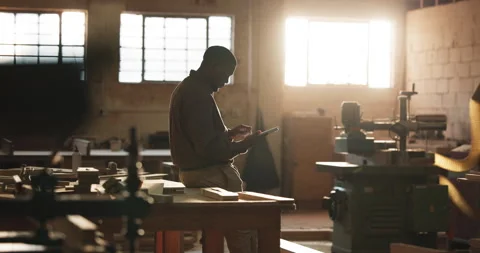 Carpenter, man and typing in workshop with tablet, research and check quote for Stock Footage 341377859