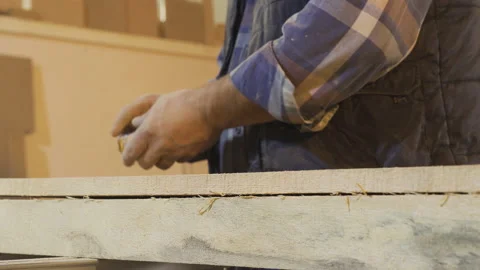Carpenter man clapping and cleaning his dusty and sawdust hands. Stock Footage 221640207