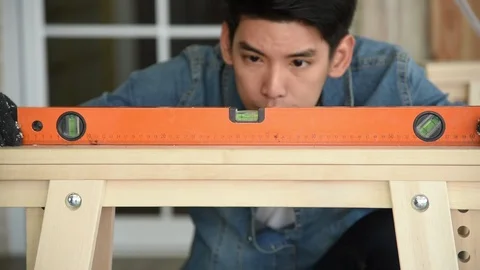 Carpenter man worker measuring and preparing to cut wood plank Stock Footage 125354618