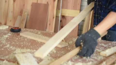 Carpenter man worker measuring and preparing to cut wood plank Stock Footage 125354953