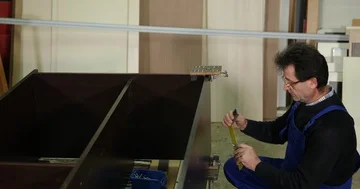 Carpenter Man Working Use Measuring Tape and a Pencil to Mark Plywood Furniture Stock Footage 85516085