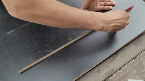 Carpenter marking mdf boards with a carpenter pencil. Constructing furniture Stock Footage 218383890