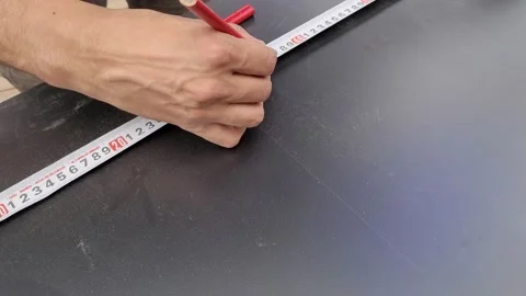 Carpenter marking mdf boards with a carpenter pencil. Constructing furniture Stock Footage 218383925