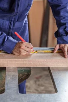 Carpenter marking a plank Fotos Stock