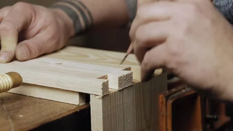 A carpenter marks a dovetail on a wooden board with a pencil. Stock Footage 166340964