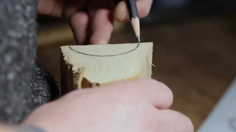A carpenter marks out a piece of wood with a pencil. the art of woodworking. Stock Footage 147869957