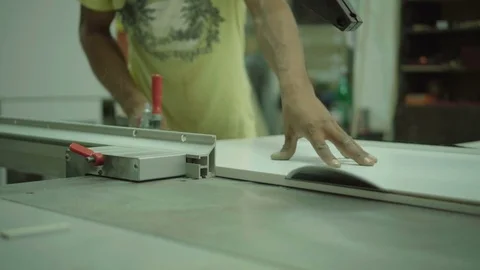 Carpenter master Cutting Wood plank corners With Circular Saw in woodwork shop Stock Footage 77665287