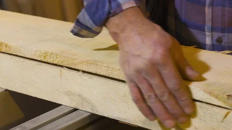 Carpenter master stroking raw wood with his hands. Employee who loves his job. Stock-Footage 221639632
