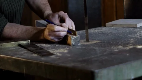 Carpenter measures and marks cutting line using a carpenter's ruler Stock Footage 88651508