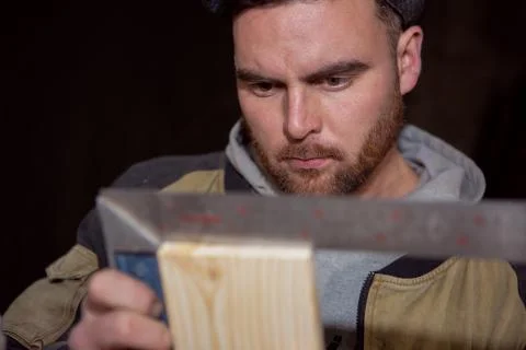 The carpenter measures the correct geometry of the Board with a square Stock Photos