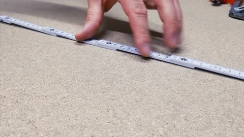 Carpenter measures the material Stock Footage 90957832
