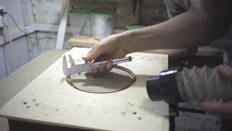 The carpenter measures the size of the gutter Stock Footage 102902641