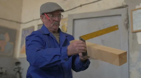 Carpenter measuring a 2 x 4 with a tape measure Stock Footage 47953812