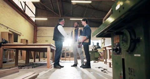 Carpenter, men and handshake in workshop with deal, discussion or manufacturing Stock Footage 340611017