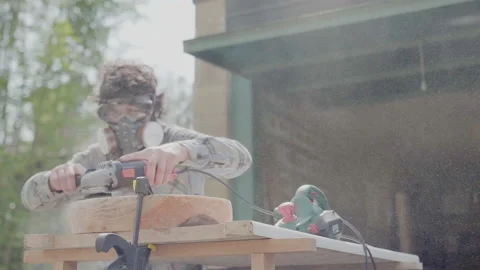 Carpenter with milling machine creating handmade wood pot outside garage Stock Footage 152798579