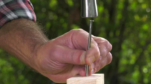 Carpenter nailing a tip with a hammer Stock-Footage 63506846
