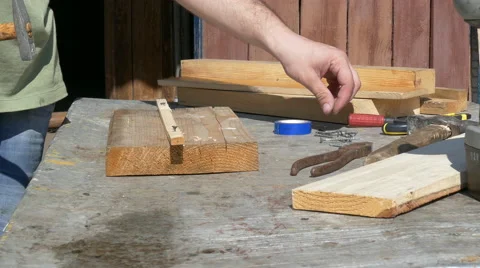 Carpenter nailing  using hammer and steel nails Stock Footage 62850372