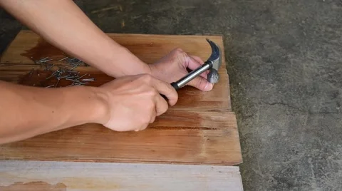 Carpenter nailing on wood board Video stock 46116830