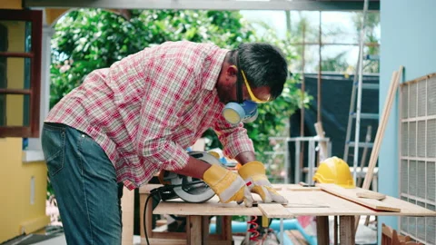 Carpenter or craftsman works by using machines to work on the construction site. Stock Footage 132093657