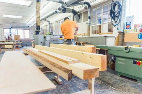 Carpenter or joiner working on logs in his workshop 스톡 사진